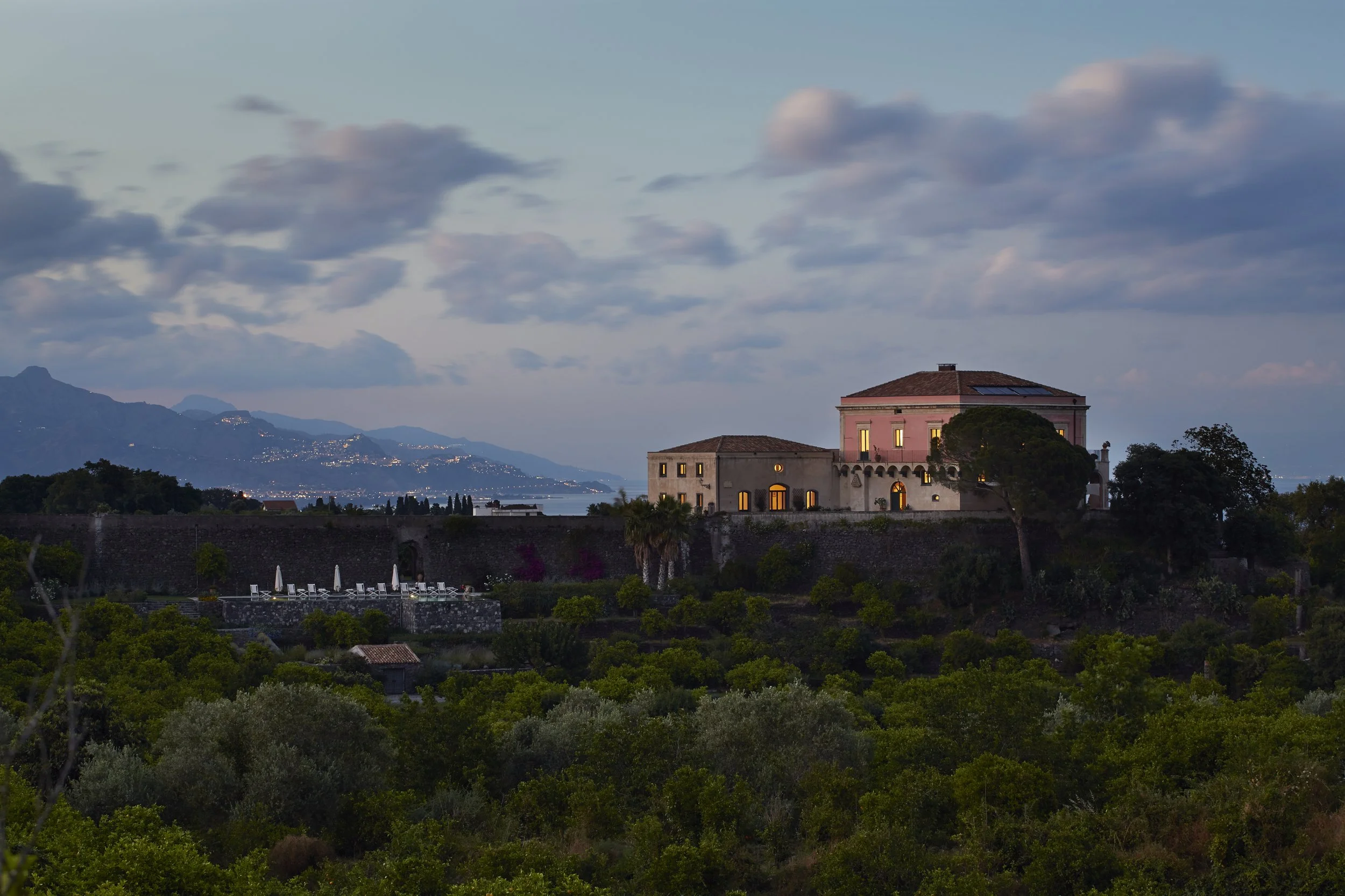 Villa in Sicily at dusk overlooking Mediterranean Sea