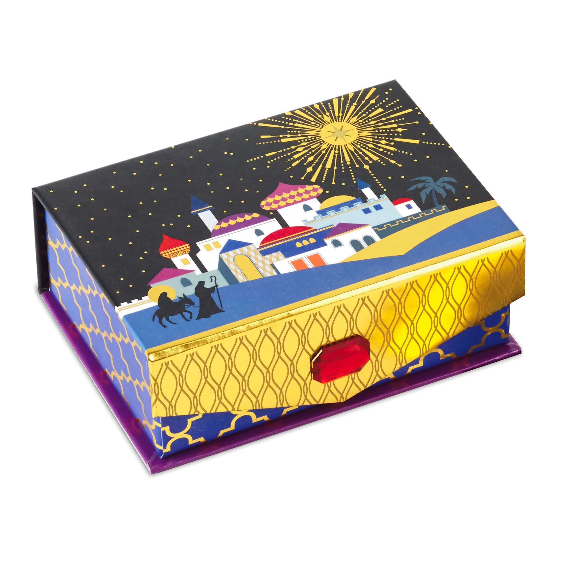 Close-up of colorful, illustrated box with Middle Eastern cityscape, domed buildings, camels, palm trees, and a starry night sky with a bright yellow sun or starburst.