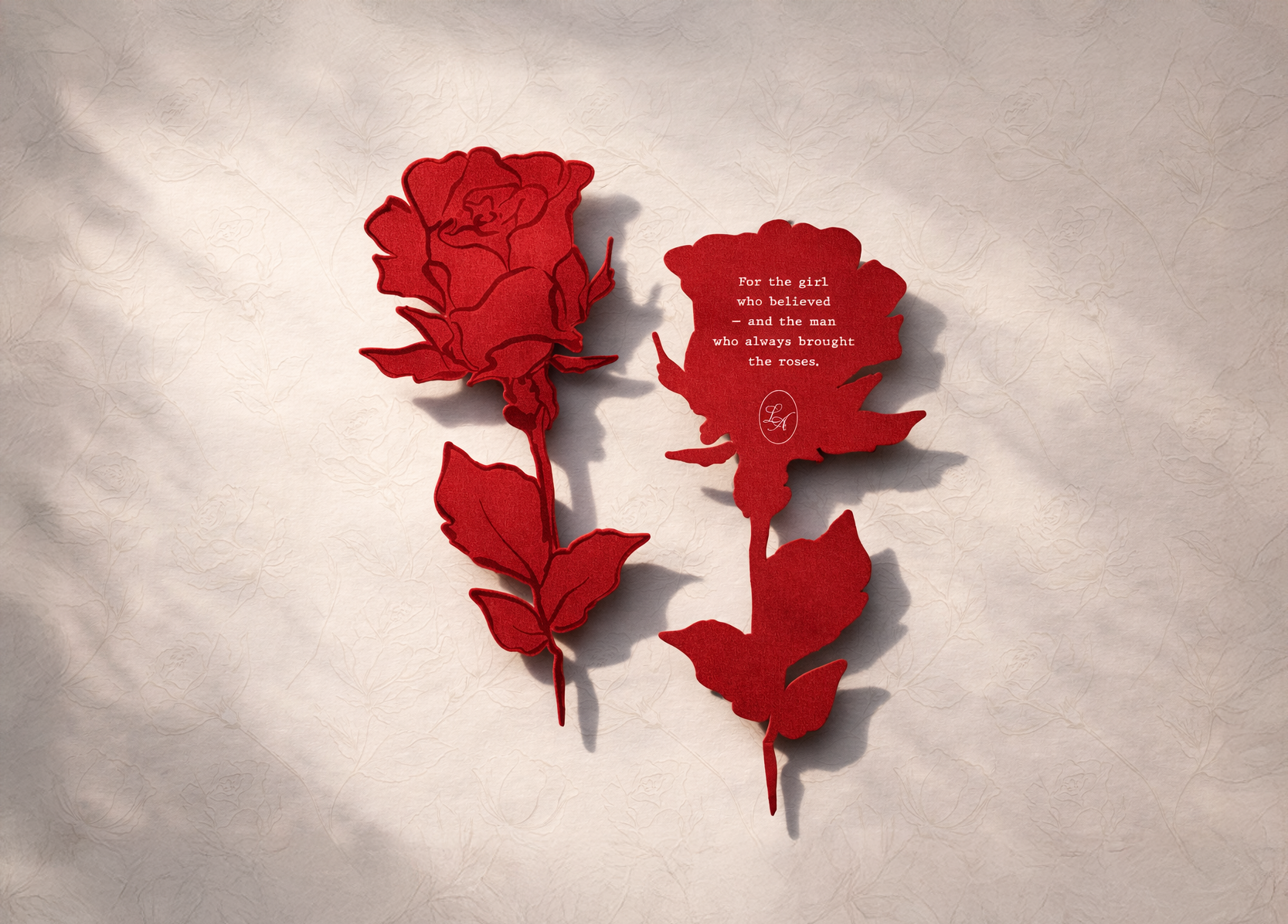 Red paper cutouts of a rose and a butterfly with a quote on the butterfly. The quote reads: 'For the girl who believed — and the man who always brought the roses.'