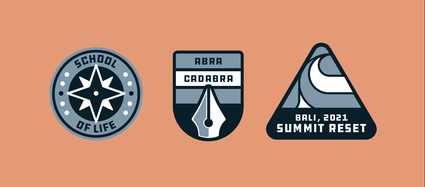 Three illustrated badges on a peach background. The first badge has a compass rose with 'School of Life'. The second badge is a stylized pen nib with 'Abra Cadabra'. The third badge is a triangle with a mountain design and the text 'Bali, 2021 Summit