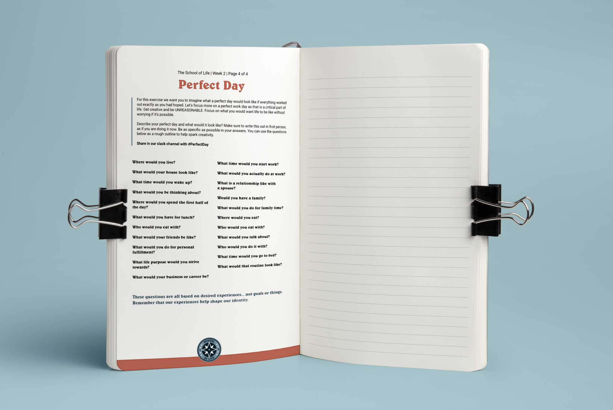 Open notebook with printed text on the left page and lined blank page on the right, clipped with black binder clips on a light blue background.