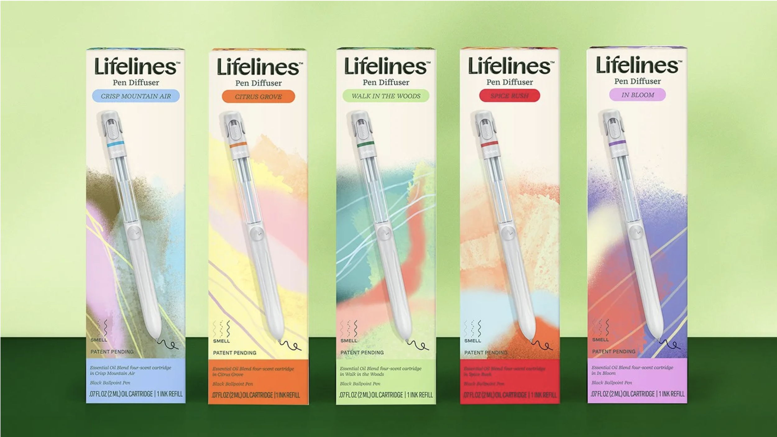 Set of five Lifelines pen diffusers in colorful packaging, each labeled with a different scent: 'Crisp Mountain Air,' 'Citrus Grove,' 'Walk in the Woods,' 'Spice Rush,' and 'In Bloom.'