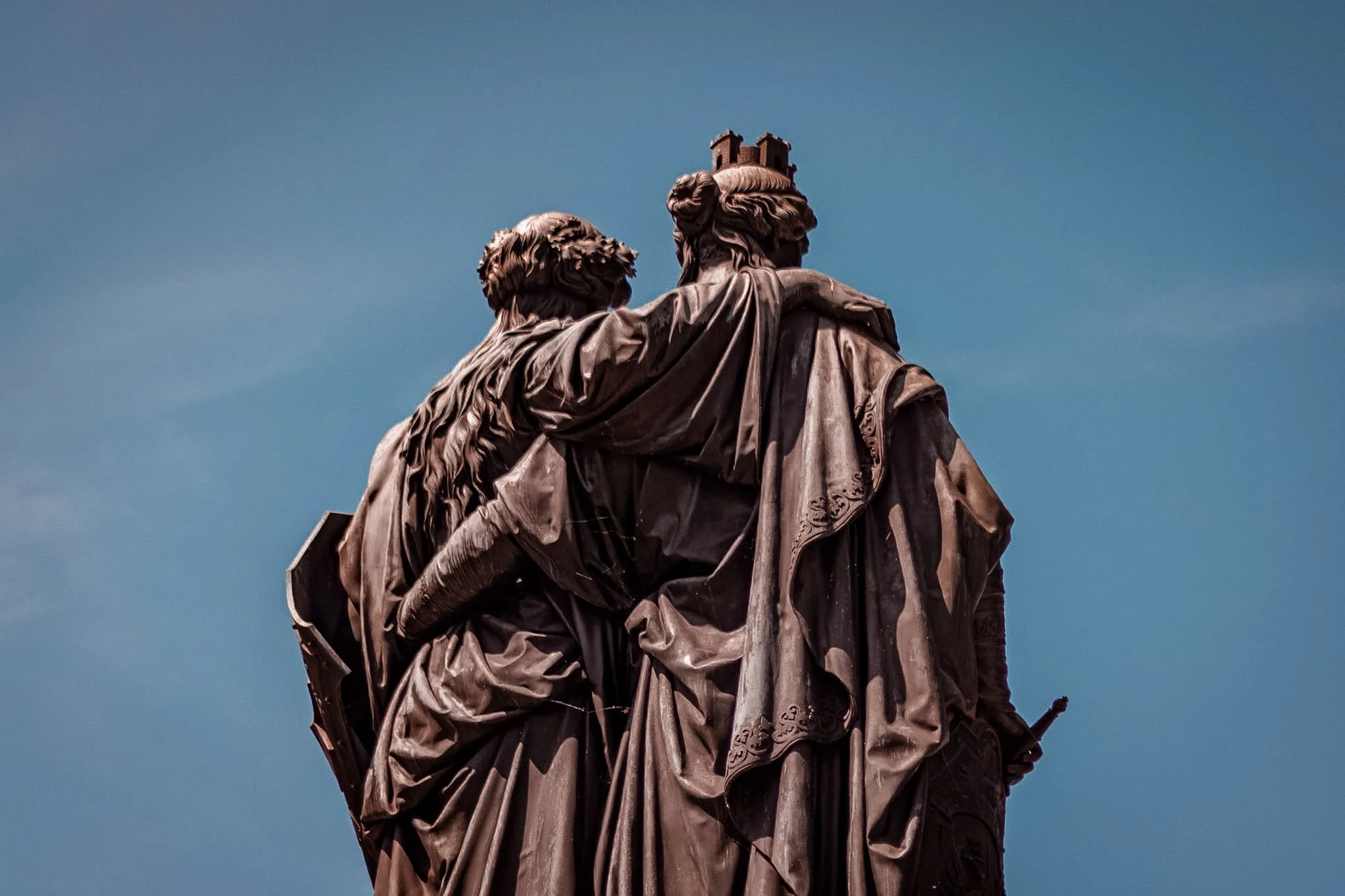 Close-up view of the Statue of Liberty's head and upper shoulders against a clear blue sky, emphasizing the detailed craftsmanship of the statue.
