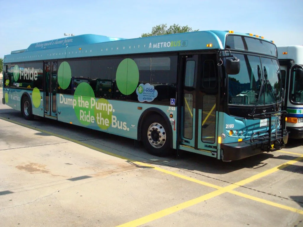 i-Ride in the wild—the "Dump the Pump" push, painted on a hybrid-electric MetroBus.
