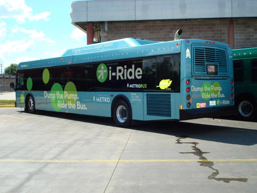 i-Ride in the wild—the "Dump the Pump" push, painted on a hybrid-electric MetroBus.