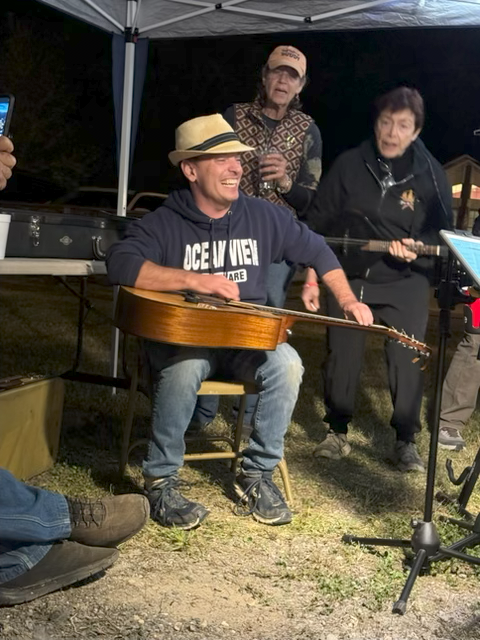 Drake Burd smiling during a nighttime performance in the Santa Ynez Valley
