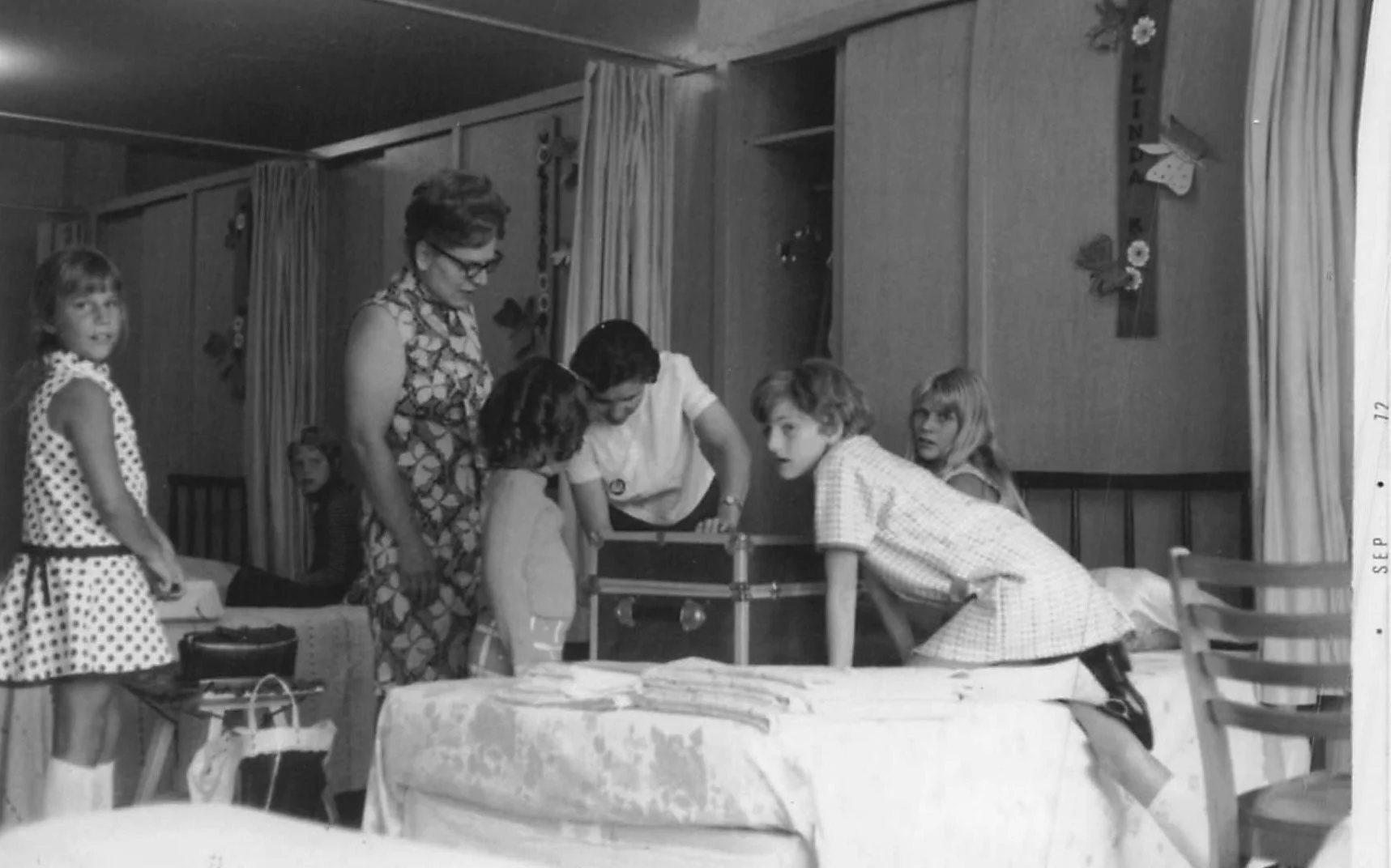 Black and white historical photo of girls in the original dormitory.