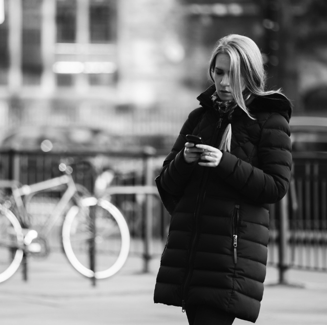 anxious woman is looking at her phone thinking about how overwhelming some of the big changes are in her life like a divorce and new job