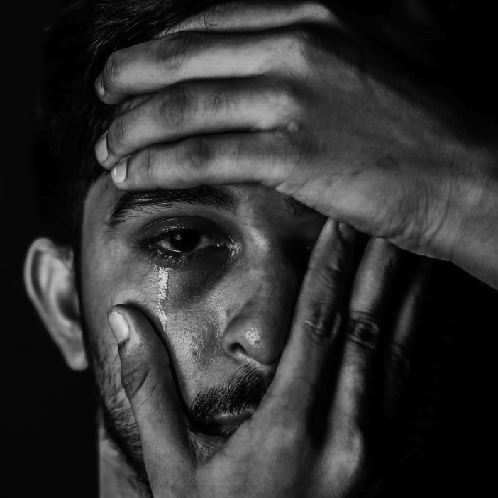 Man who is expressing sadness before receiving EMDR to help process his grief and loss in West Seattle Center for Grief, Loss, and Transition