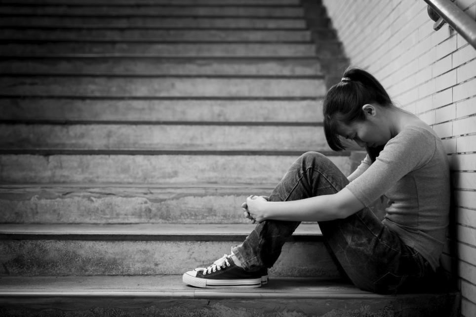 Woman looking sad thinking about her depression and exhaustion from being in grief and loss during a difficult transition