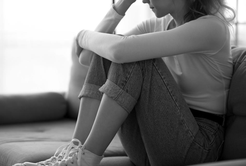 Woman feeling the depression, anxiety, and other difficulties of grief following the death or loss of someone who she cared about