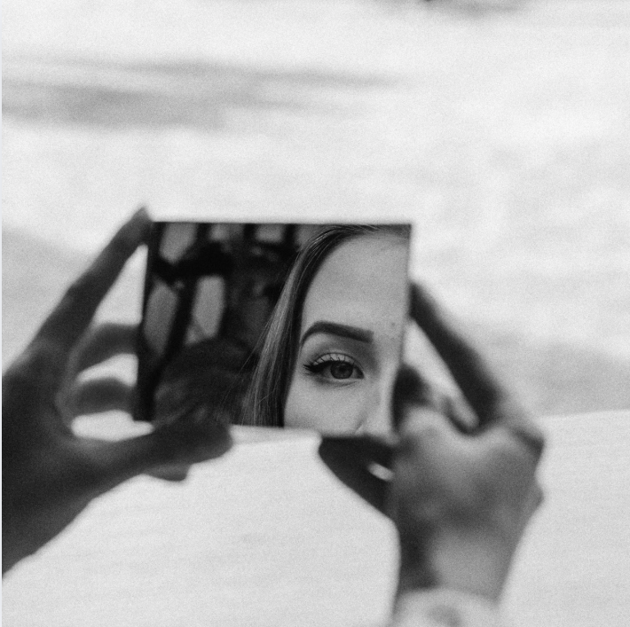 someone who is using mirror to look at themselves and think about the grief they feel and how they're doing dbt for grief in west seattle at the west seattle center for grief, loss, and transition