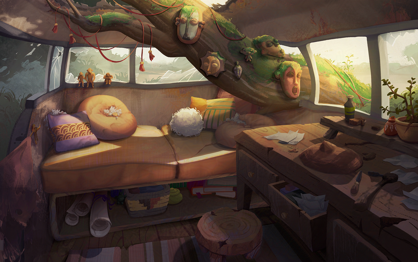 Inside a van home with large windows and natural light, decorated with tribal masks and sculptures on a tree branch, a comfortable sofa with pillows, knitted items, and a cluttered wooden desk with papers, tools, and potted plants.
