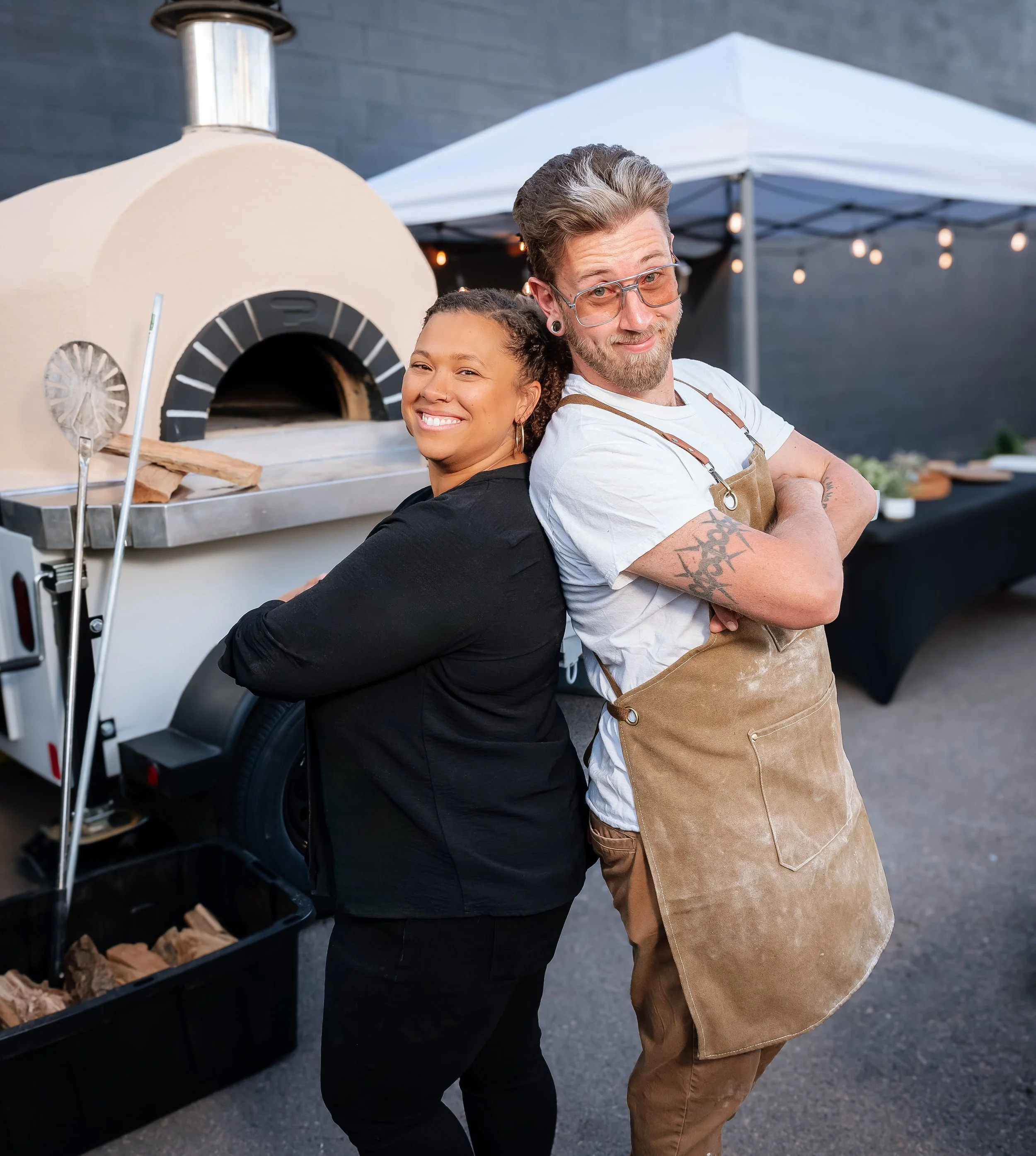 Owners of Wildfire Cuisine Co. wood-fired catering at a Colorado wedding
