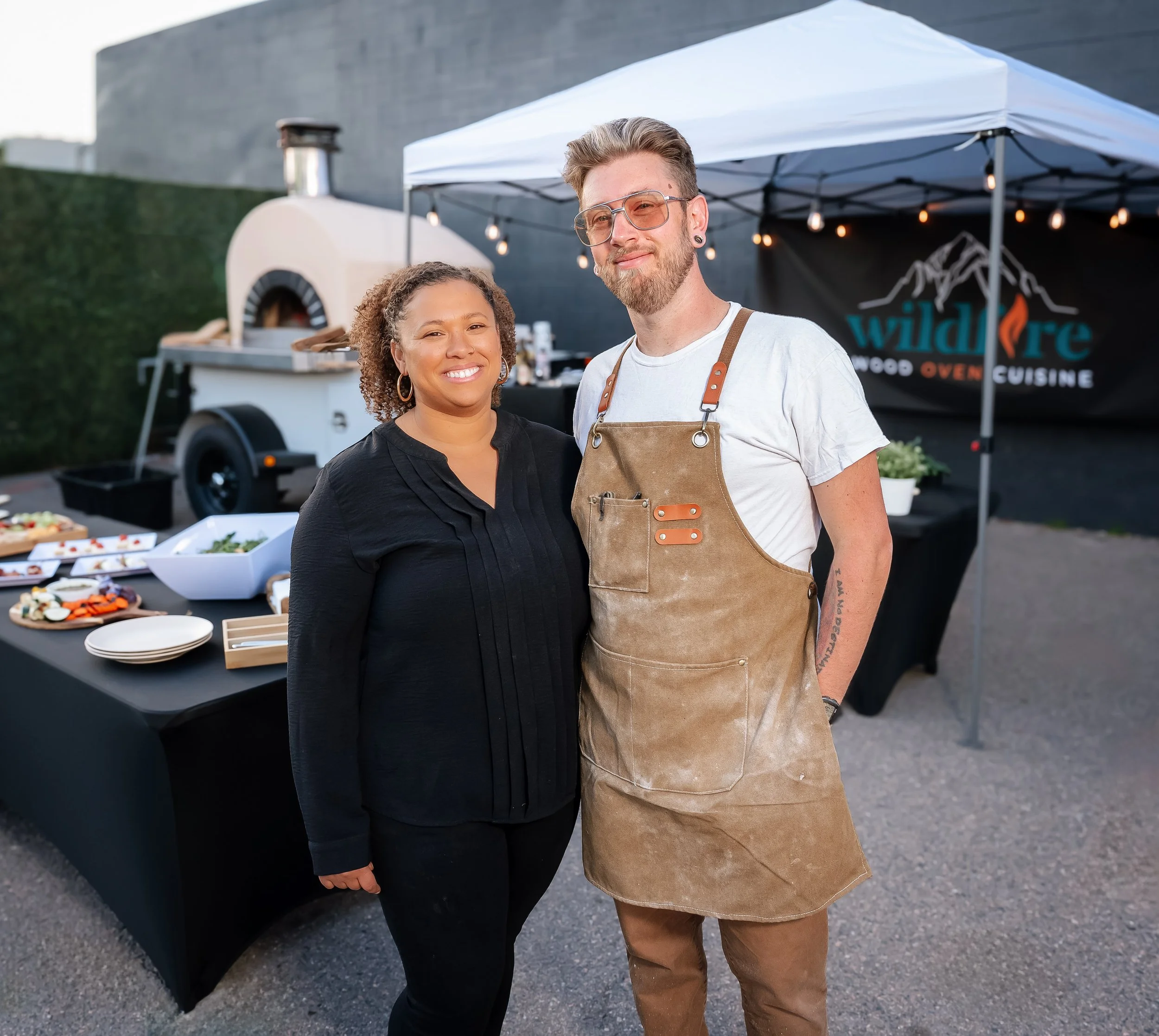Owners of Wildfire Cuisine Co. wood-fired catering at a Colorado wedding