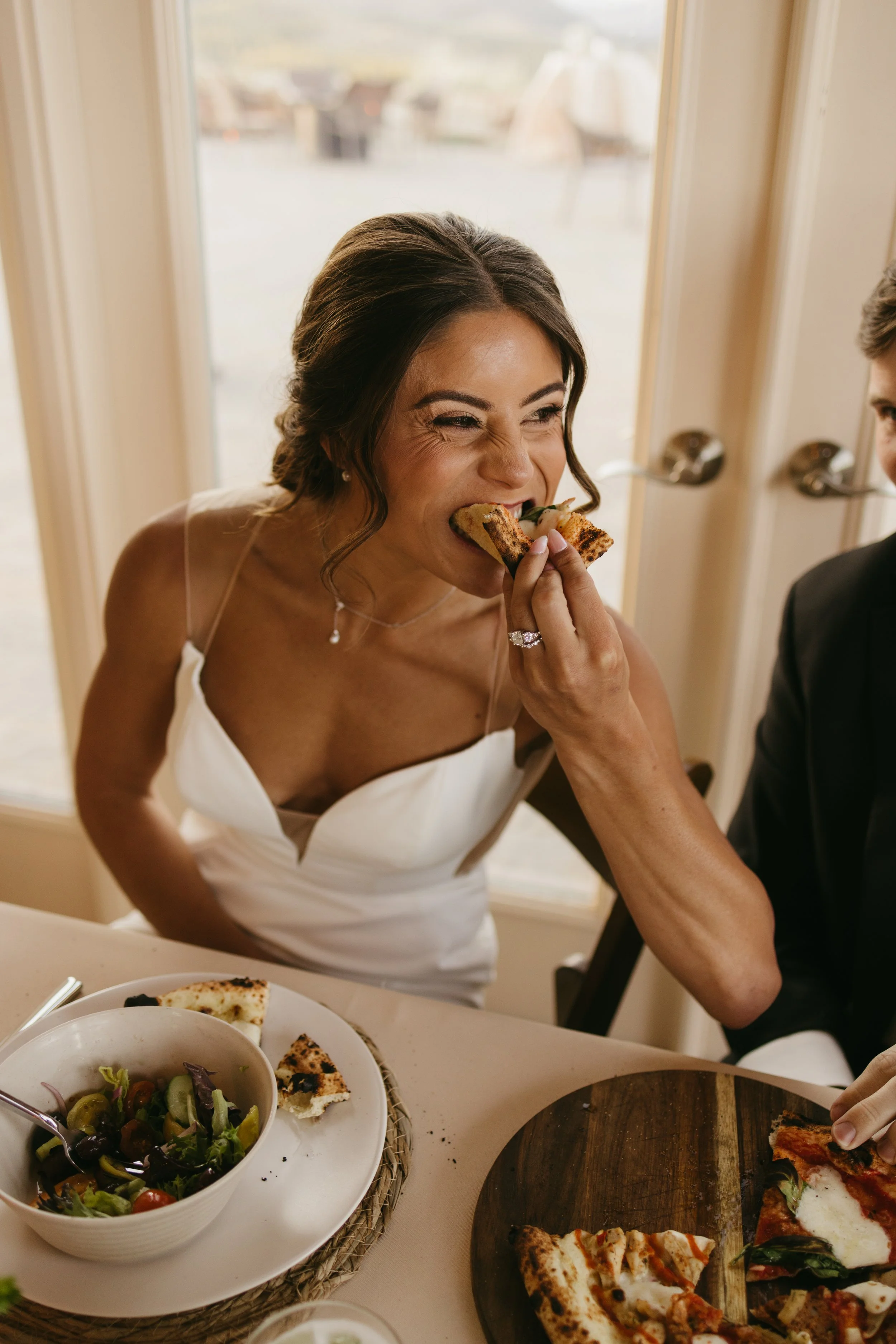 Colorado bride eating pizza. Photo by: Shiloh Rose Photo Film