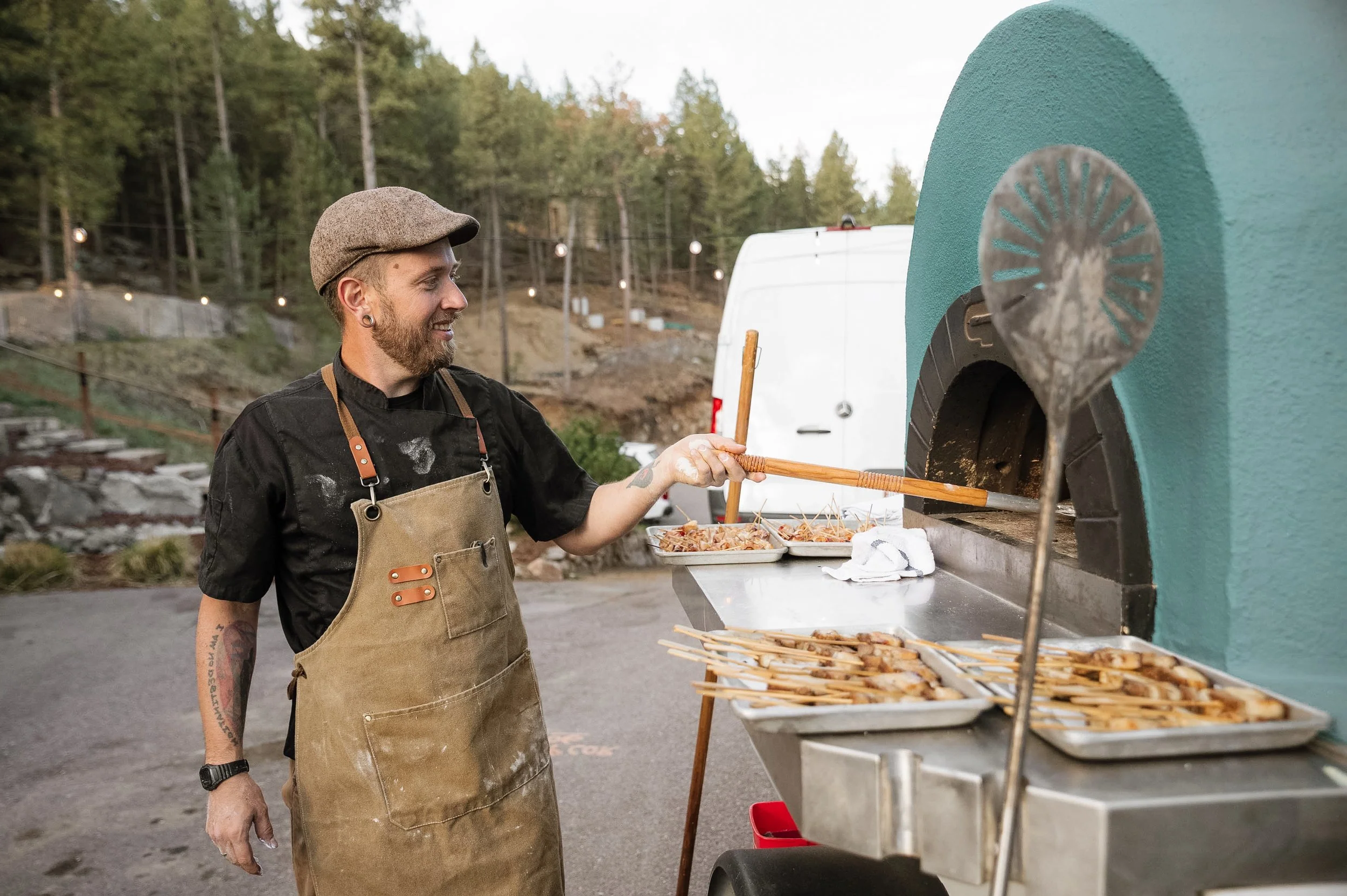 Owners of Wildfire Cuisine Co. wood-fired catering at a Colorado wedding