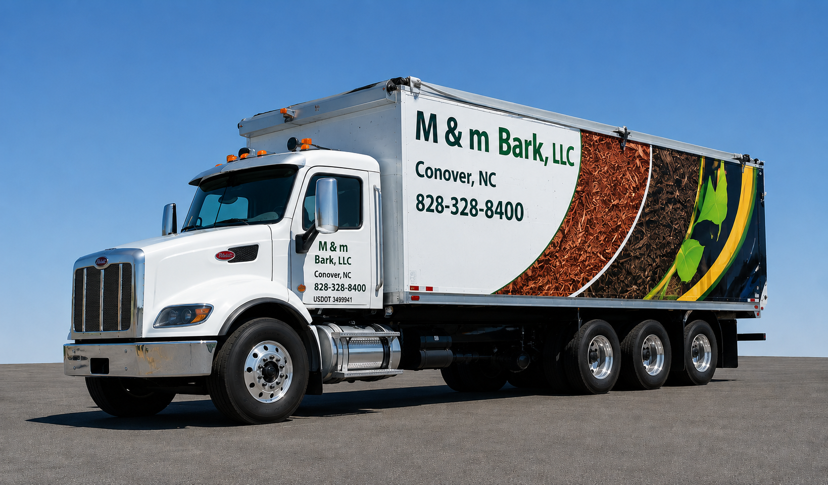 A white truck with the logo and contact information for M & m Bark, LLC, a business based in Conover, North Carolina, parked on an empty asphalt surface under a clear blue sky.