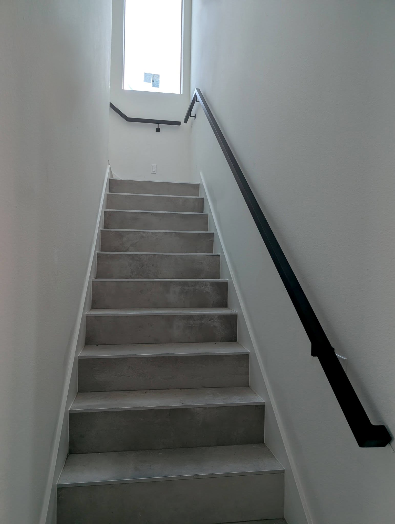 Black aluminum railing stairway looking up - White balance touch up.jpg
