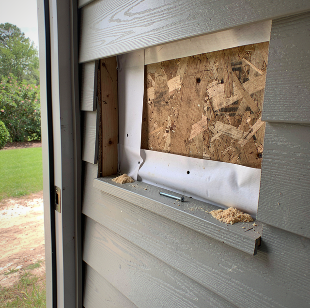 cracked vinyl siding panel under kitchen window