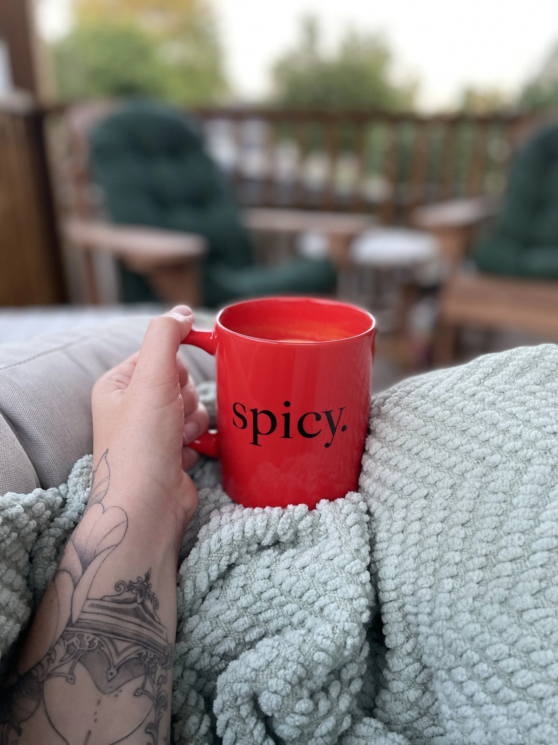 Hand holding a coffee mug, representing conversation-based business education and collaborative learning for entrepreneurs.