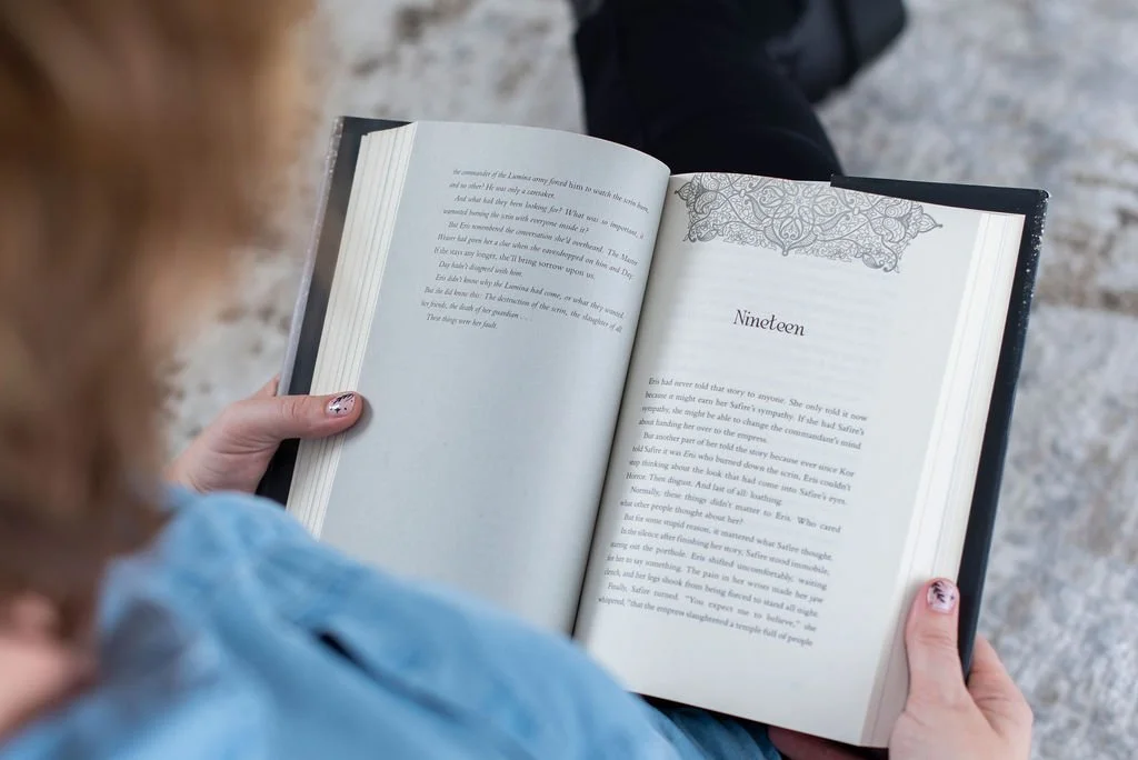 Open book held in someone's hands, representing thoughtful learning, reflection, and practical business education for entrepreneurs.