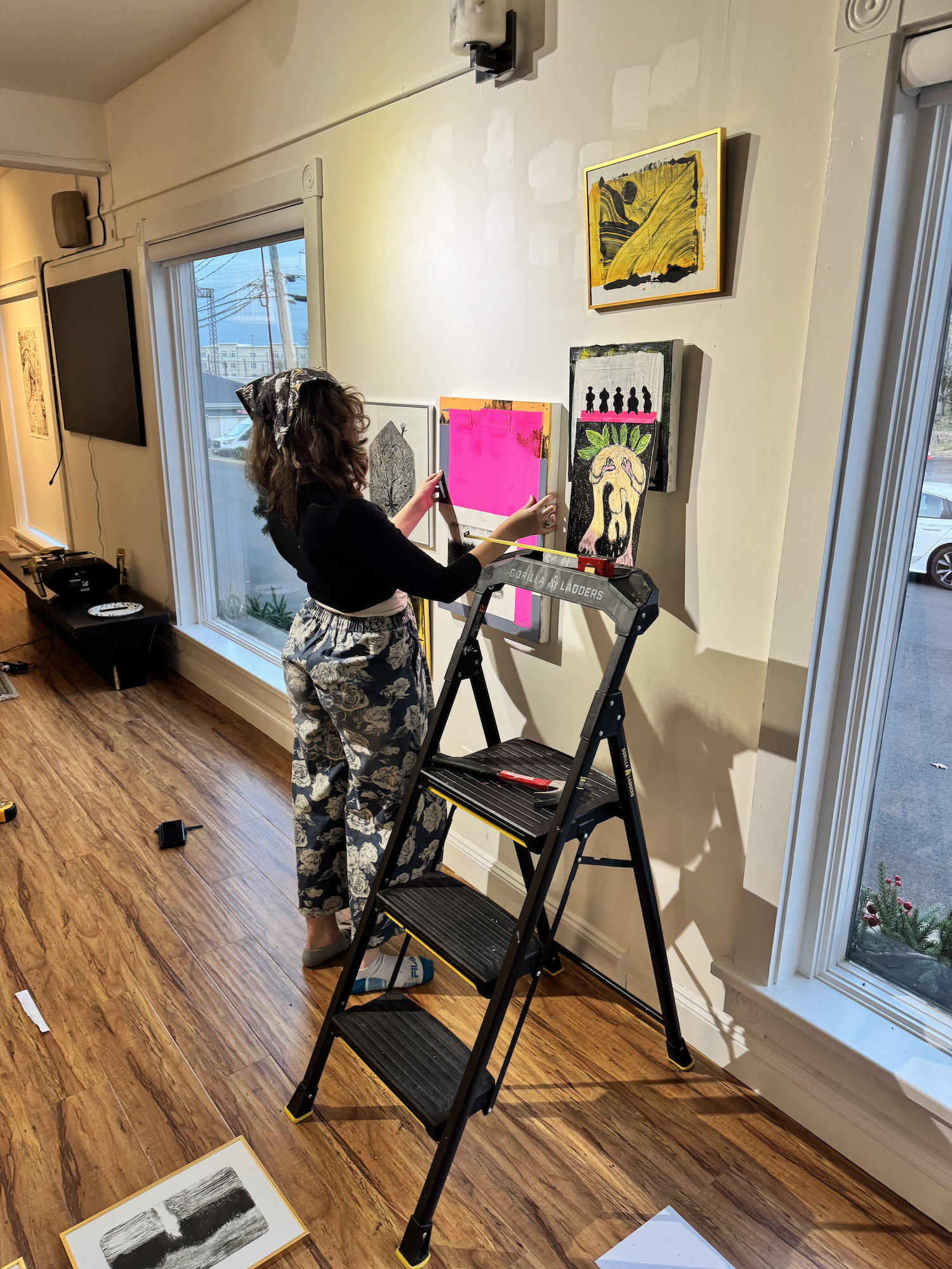 Open Archways curator hanging artwork