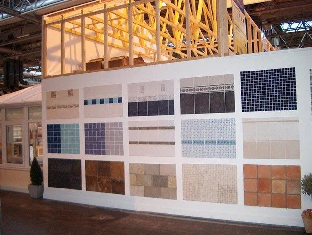 Display wall showing various tile samples in a showroom.