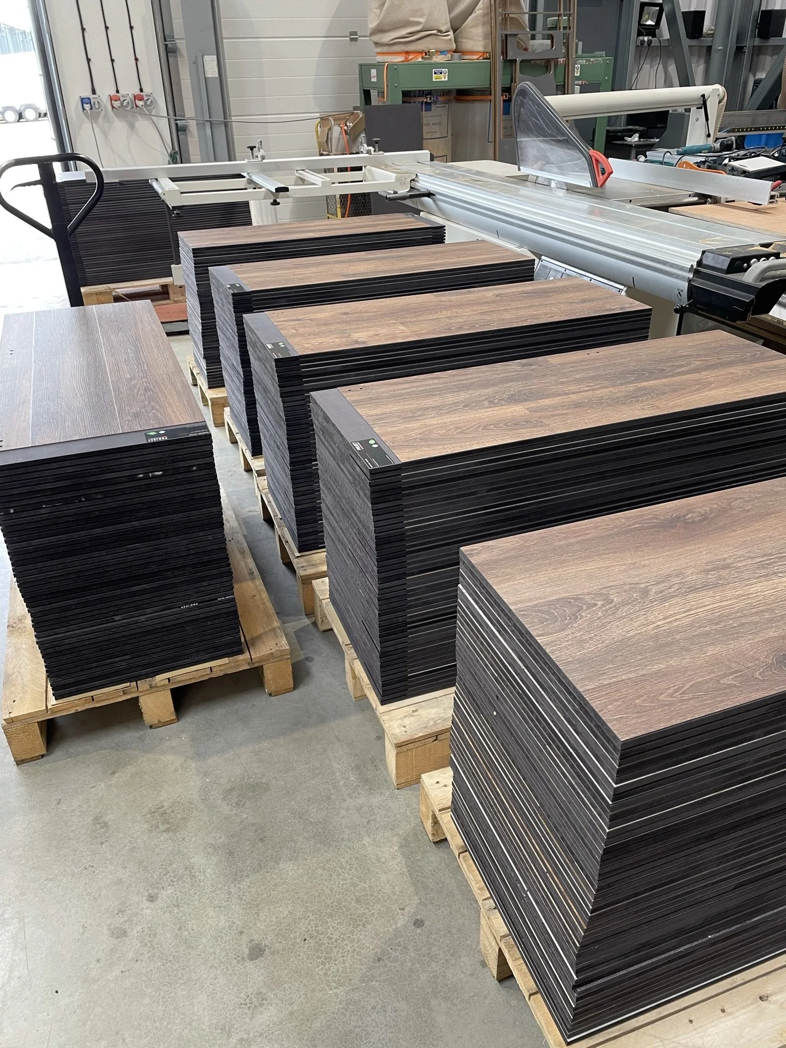 Stacks of wooden boards on pallets in a warehouse