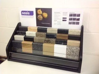Display rack with various countertop samples in different colors and textures, labeled "oasis."