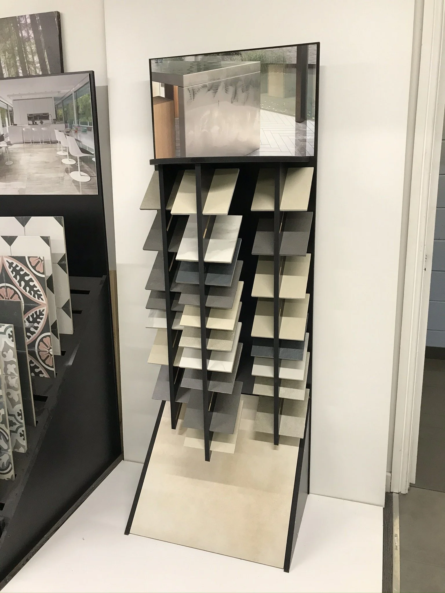Display rack with various tile samples in a showroom