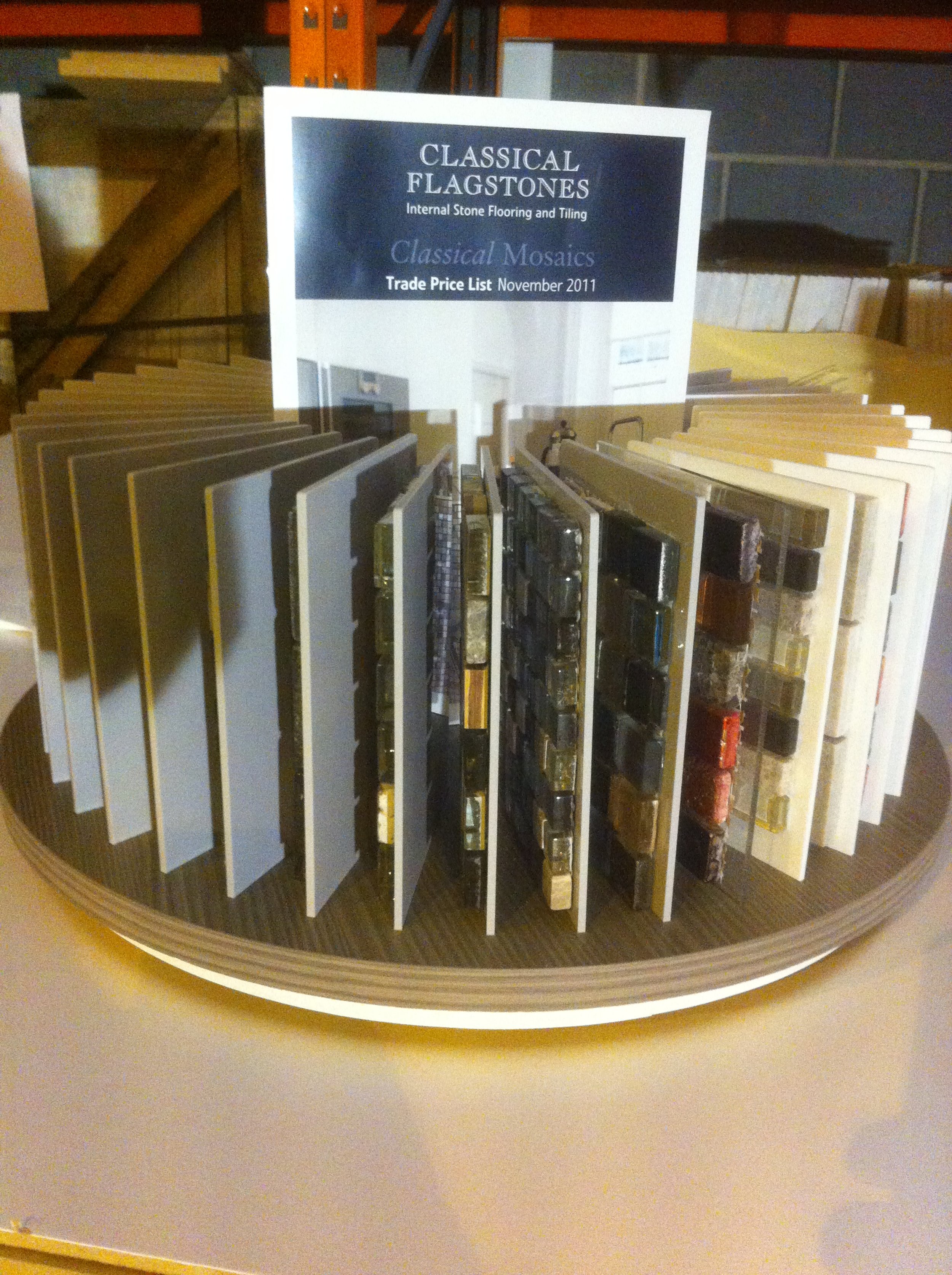Rotating display of stone flooring and tile samples labeled "Classical Flagstones," showcasing various classical mosaics.