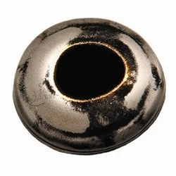 Close-up of a metallic, circular object with a central hole