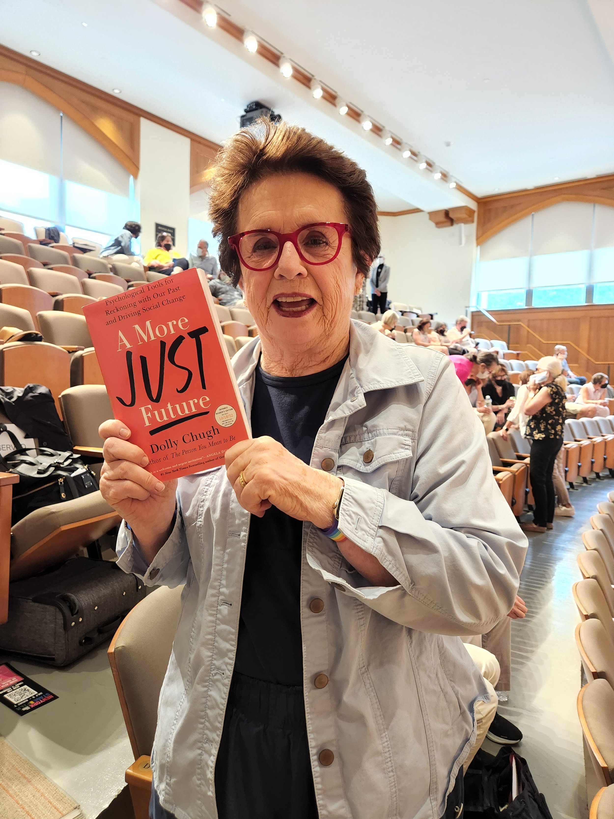 Billie Jean King holding A More Just Future book
