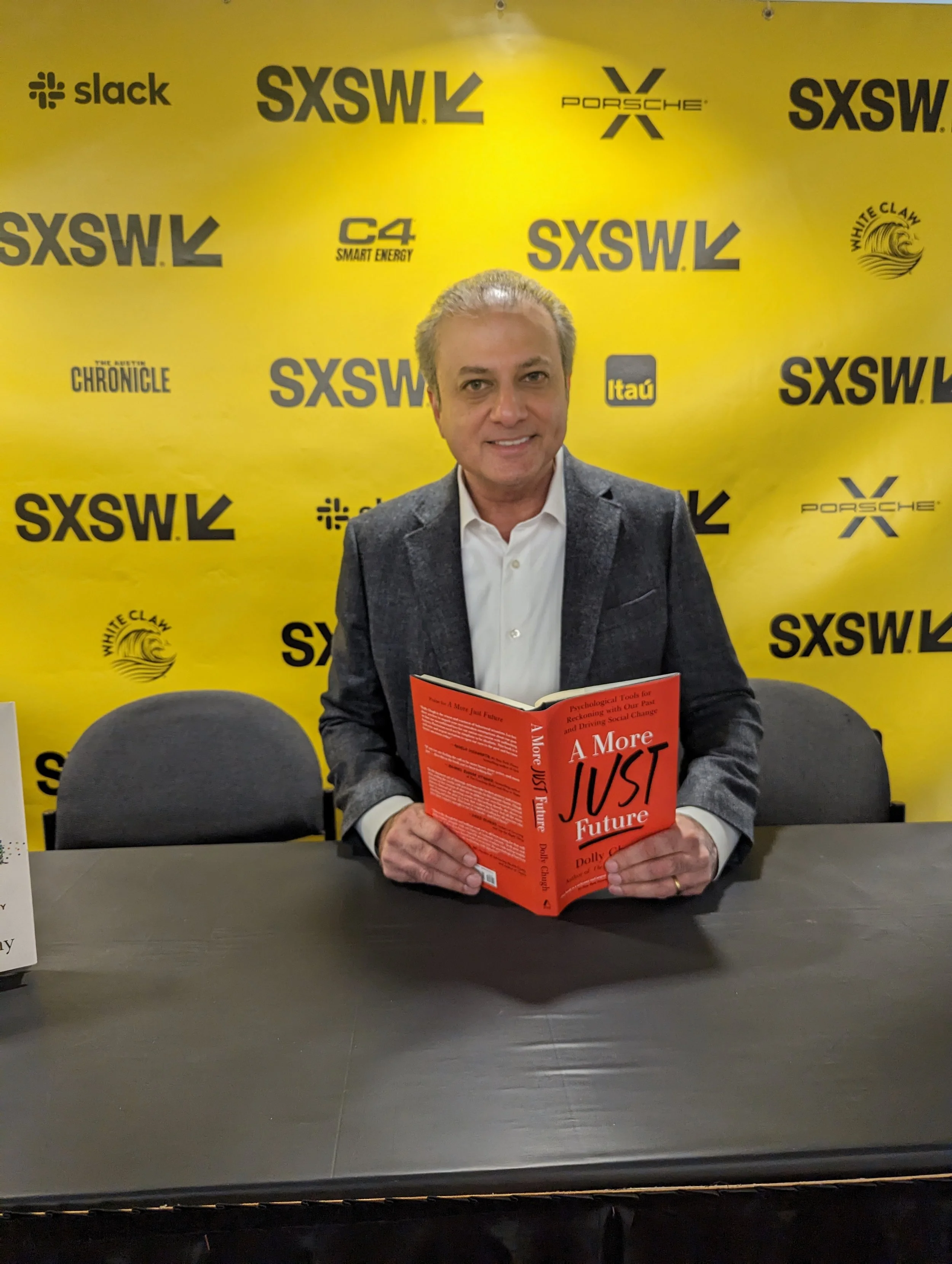 Man at SXSW holding A More Just Future Book