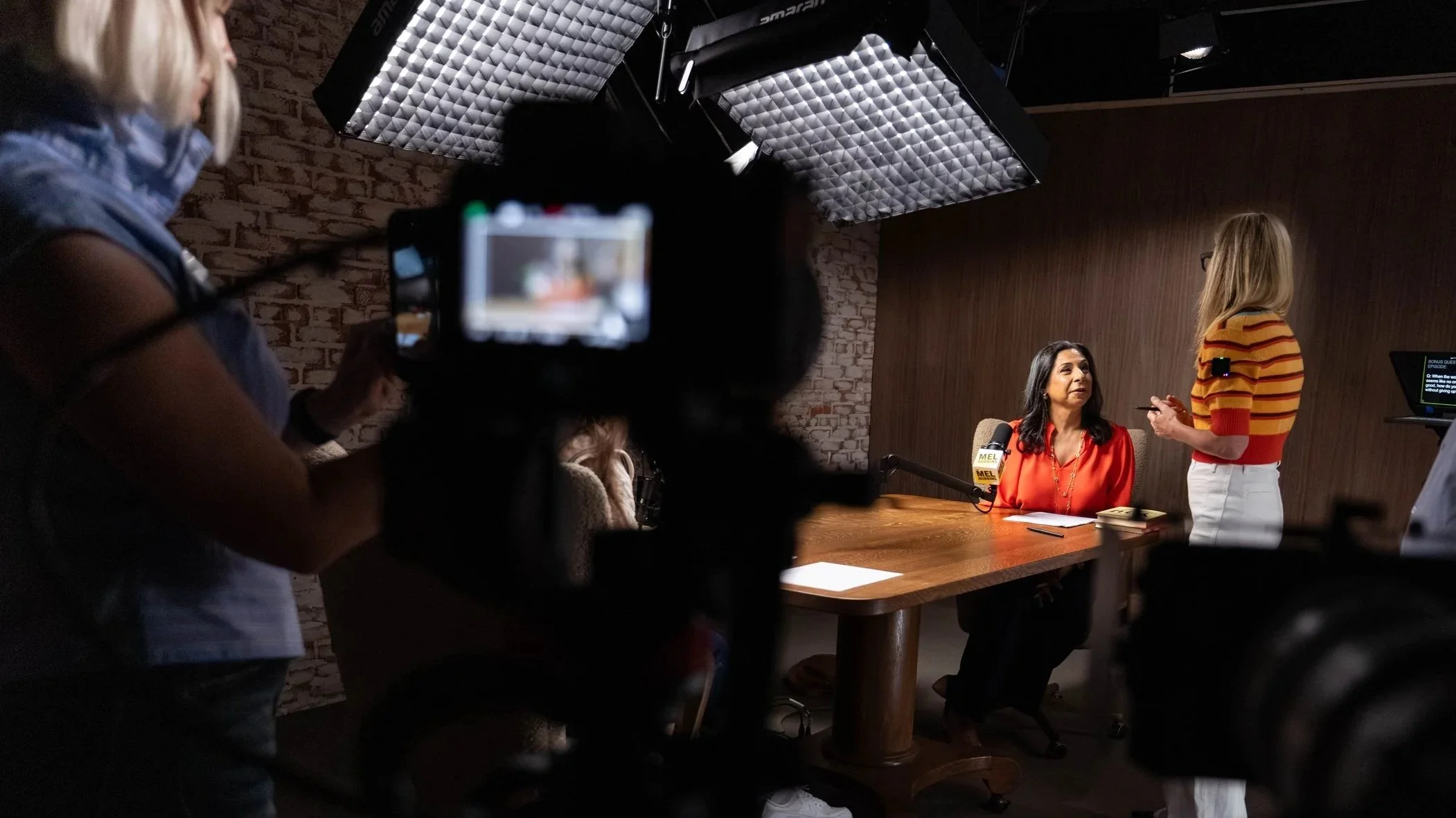 Dolly Chugh on set with Mel Robbins with camera crew
