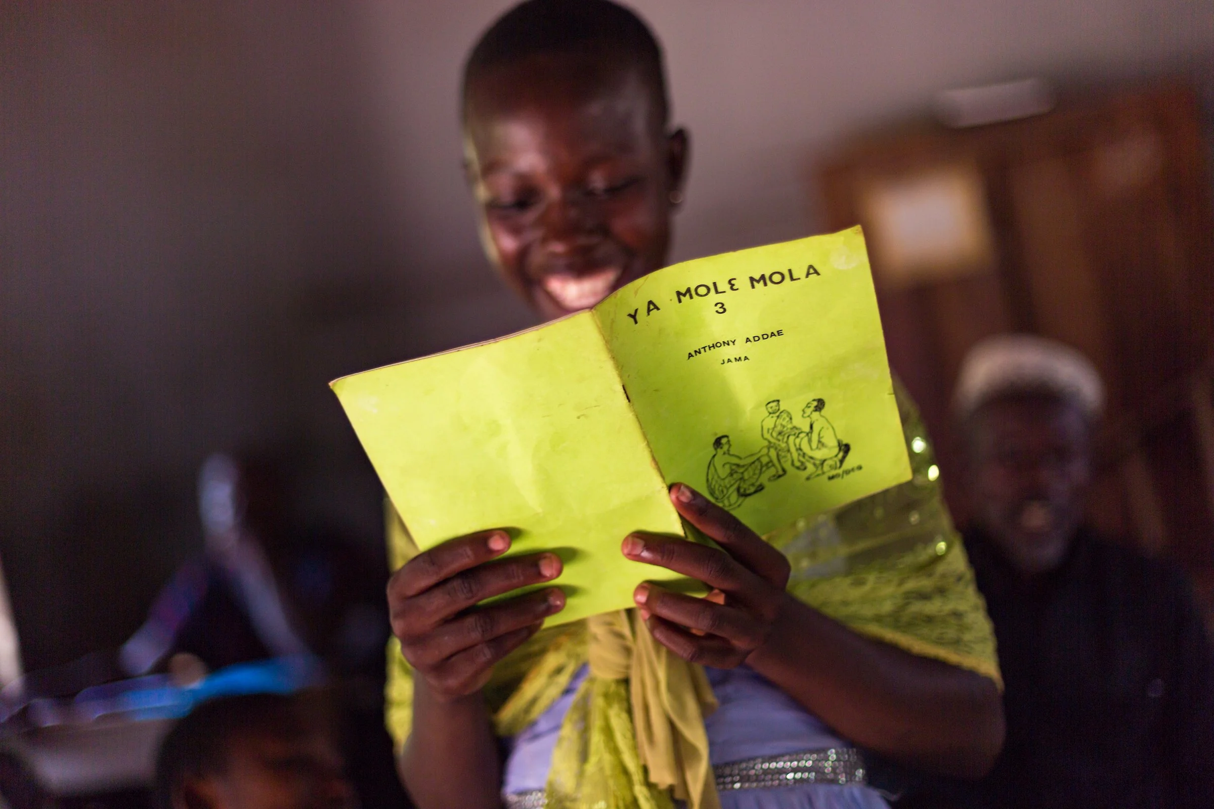 Bajoroge Joyce, who speaks Deg, reads from a Deg primer in her literacy class held in the Jama community in the Brong Ahafo Region of central Ghana.