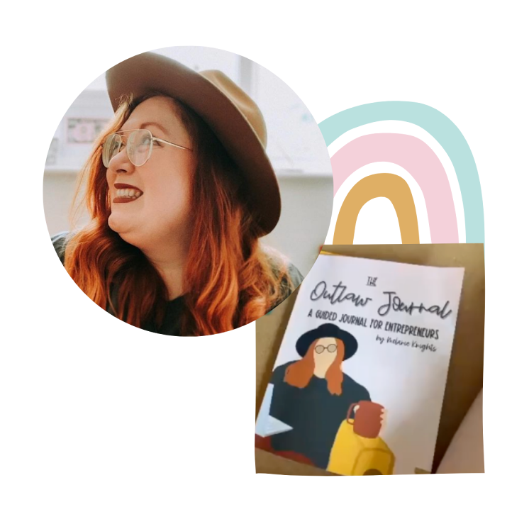 A woman with red hair, glasses, and a wide-brimmed hat smiling, sitting indoors. In front of her, there's a book titled 'The Outlaw Journal: A Guided Journal for Entrepreneurs' by Alaina Kuehn.