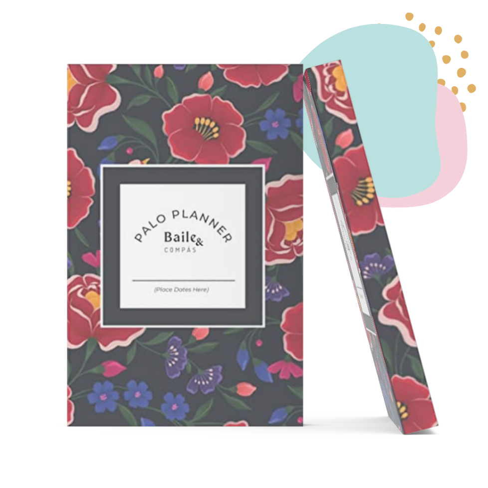 A floral planner with a dark background, decorated with red, pink, purple, and green flowers, featuring a white label on the front that reads 'Palo Planner Bail & Compass' and has space to write dates.