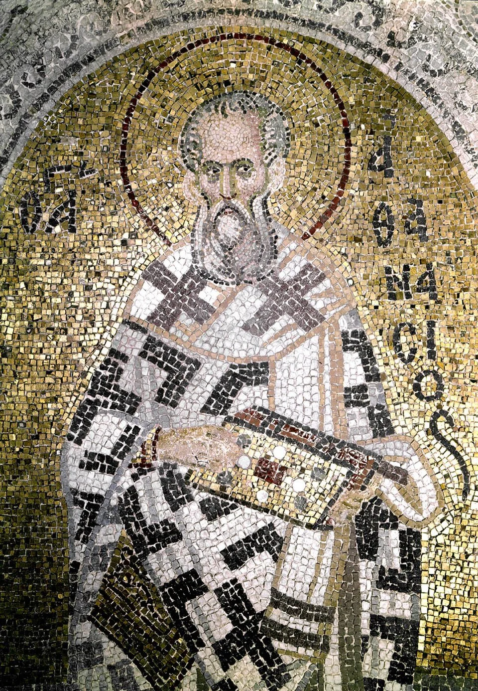 Mosaic of Jesus Christ holding a book and making a gesture of blessing with a halo around his head.
