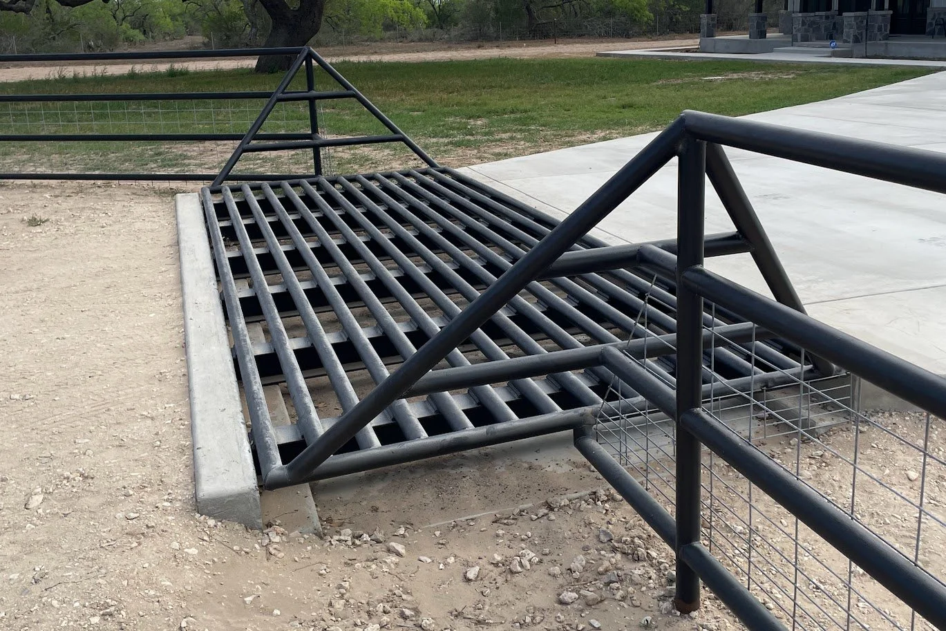 Cattle guard at entrance of driveway.