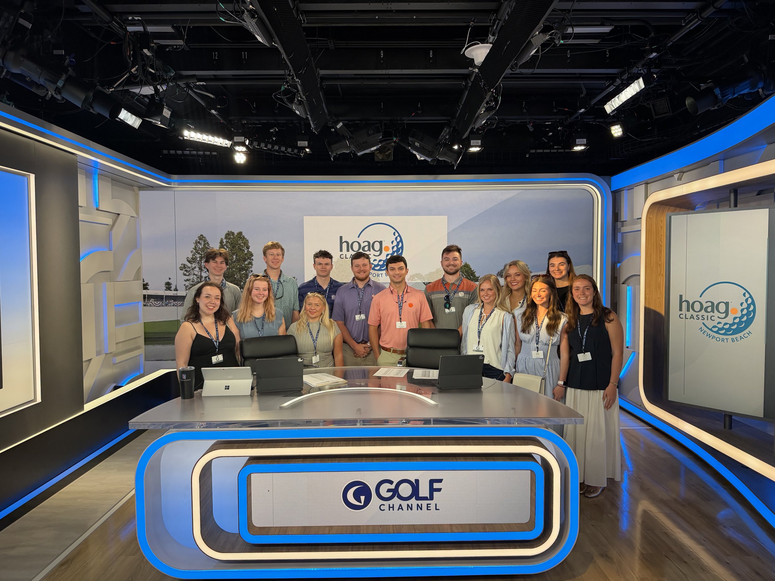 Group of young adults smiling and standing together in a TV studio with 'GOLF Channel' branding and logo.