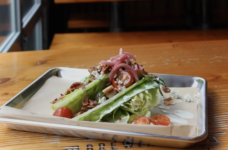 The Wedge salad with bacon, pickled red onion and bleu cheese