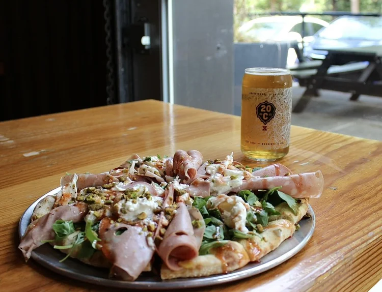 Woodstone pizza with Italian meats and a pint of 20 Corners beer