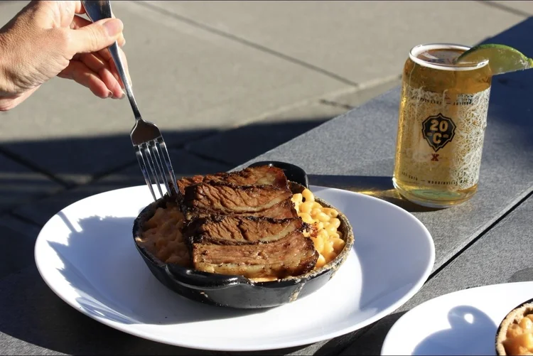 Smoked brisket over cast-iron mac and cheese with a 20 Corners can