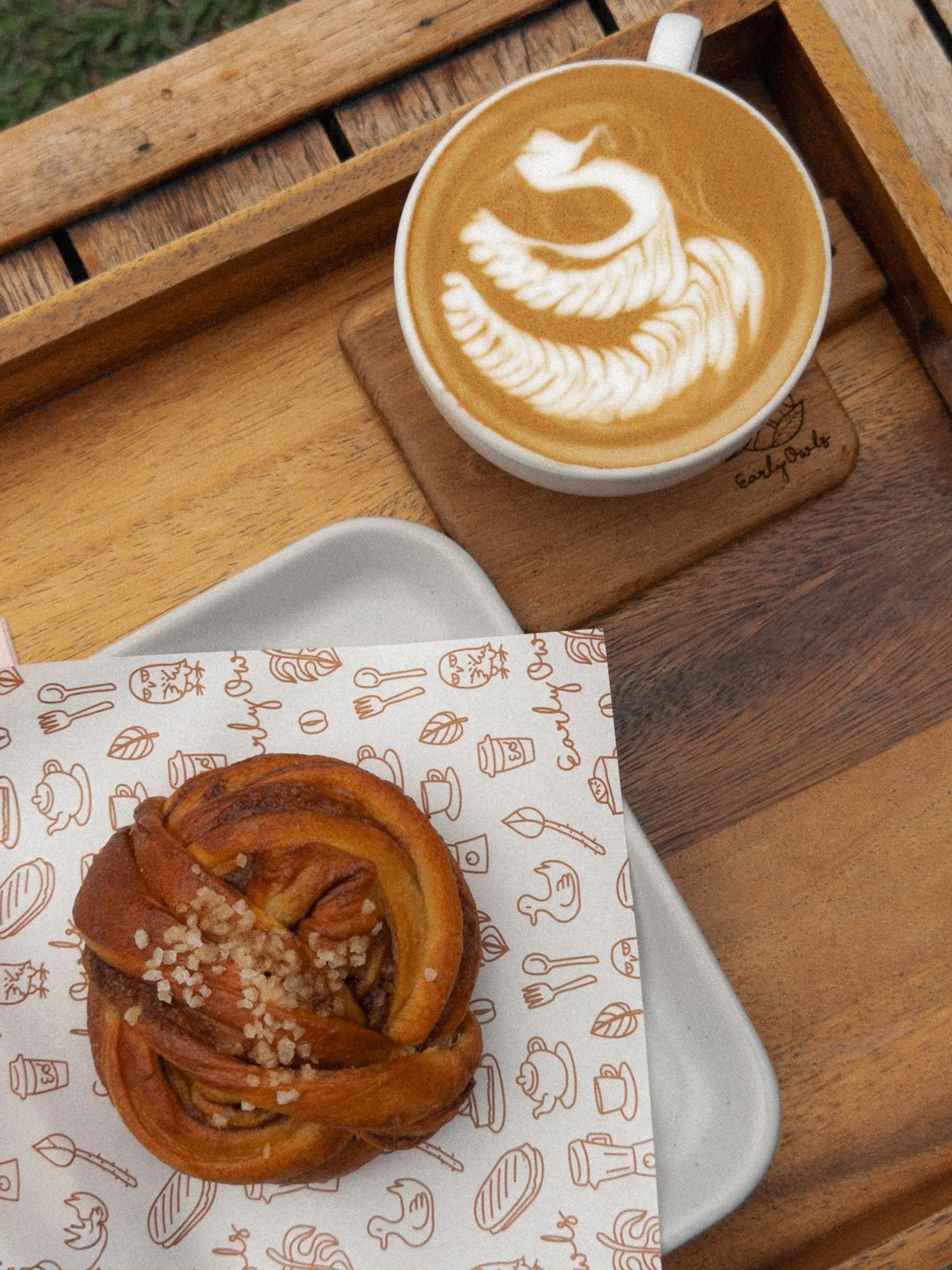 Picture shows some bakery and coffee on a wooden table in Chiang Mai Thailand
