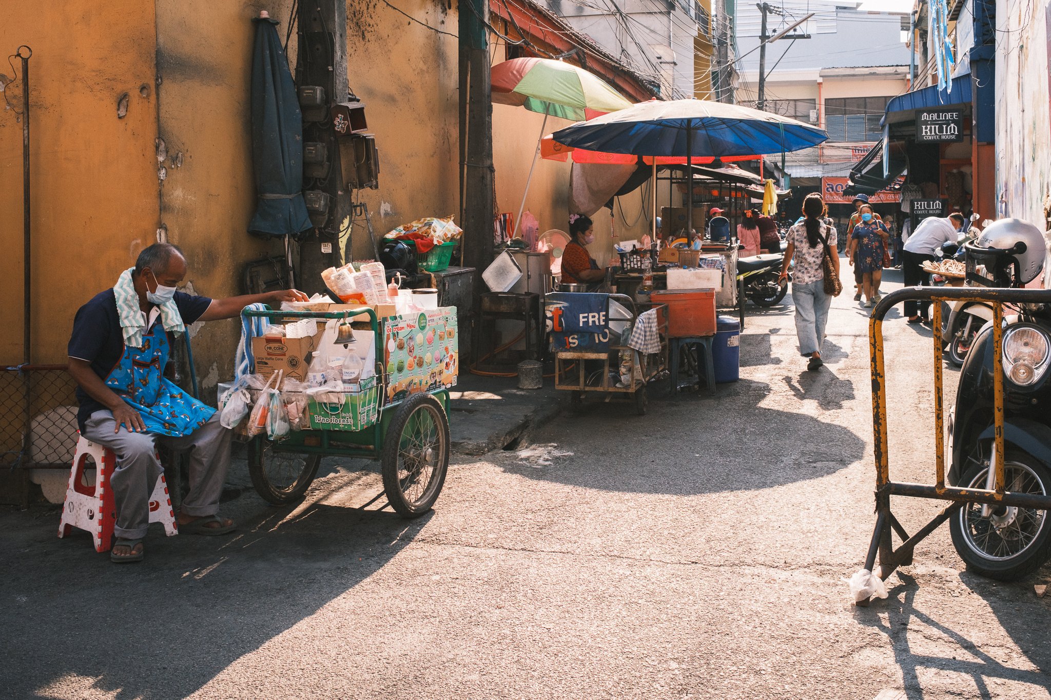 Several stands with food and goods on a street in Chiang Mai Thailand