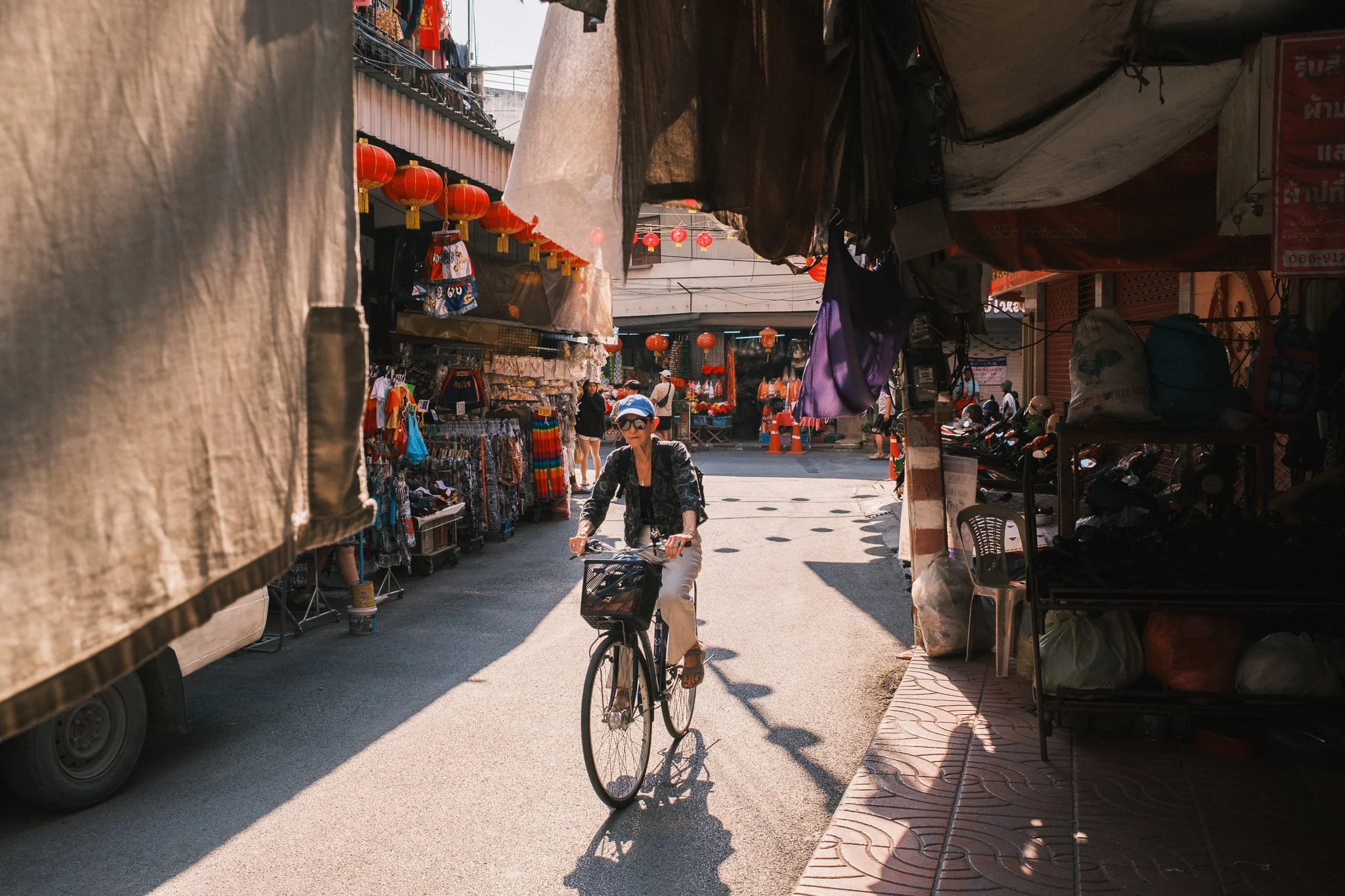 Woman on a bicycle in the streets of Chinatown in Chiang Mai Thailand