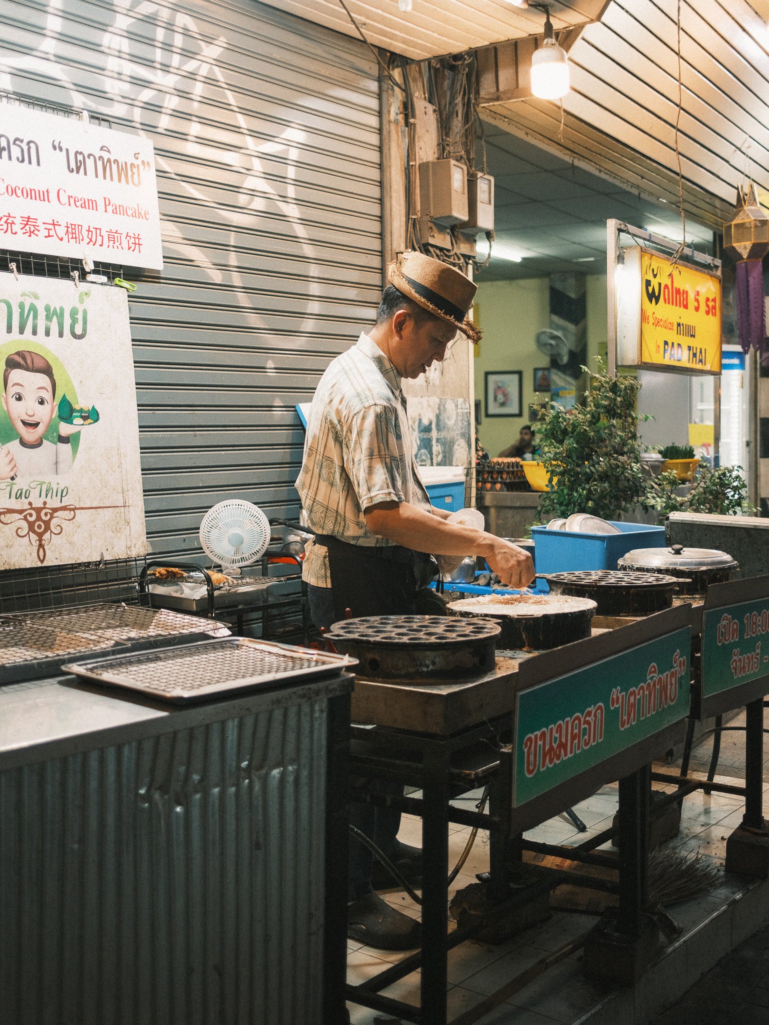 A Man cooking at his food stand in Chiang Mai Thailand