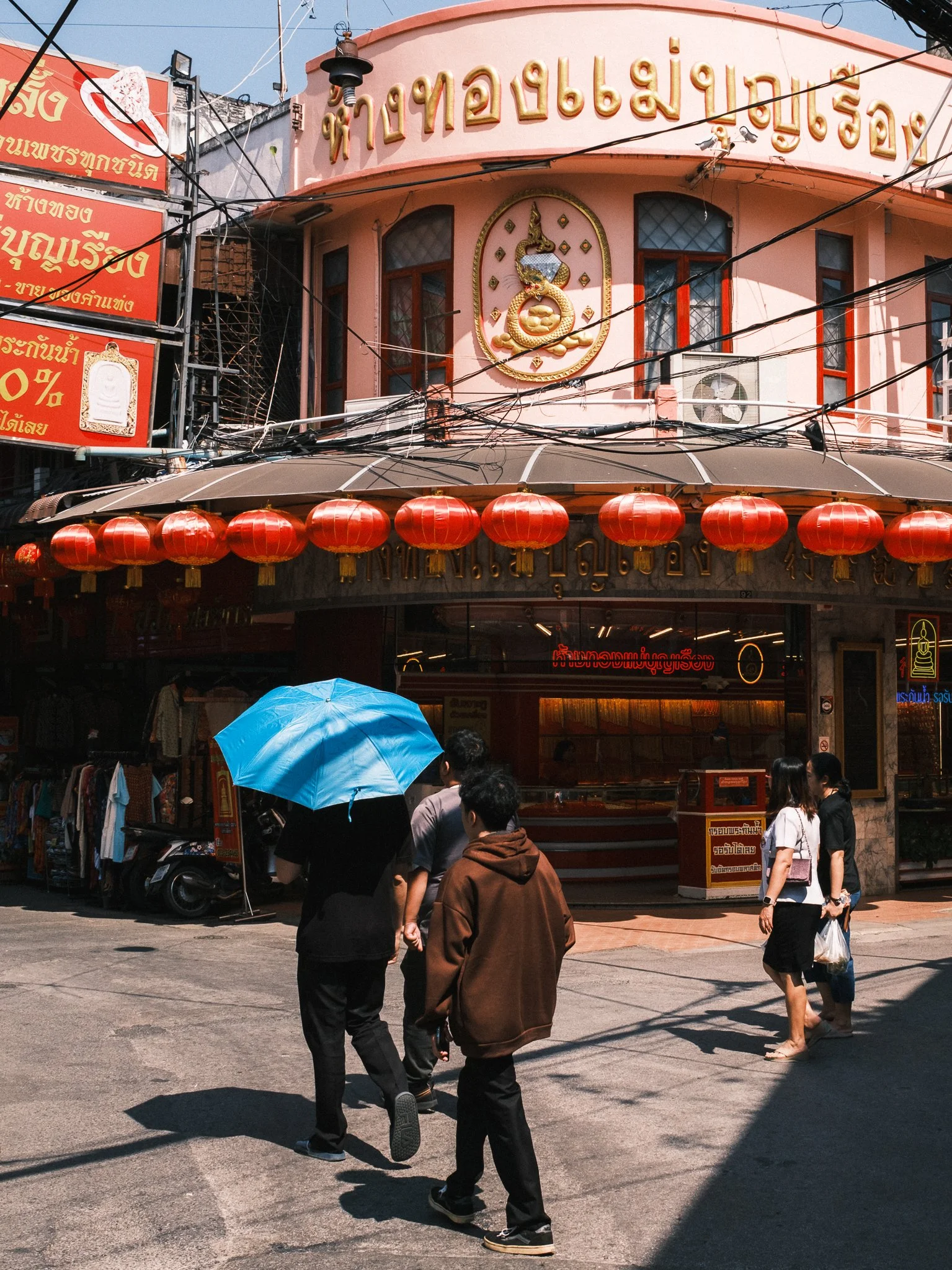 Corner in Chinatown Chiang Mai with shops and people walking on the street